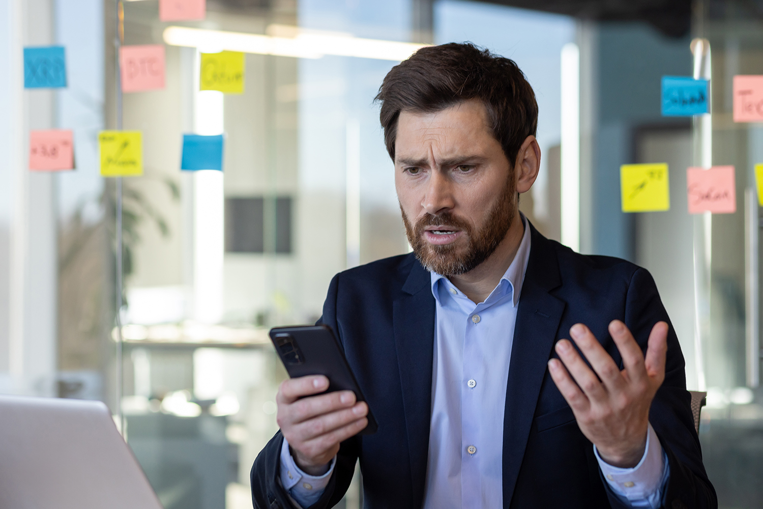 Sad disappointed businessman reading news on phone, man in business suit using app on smartphone, looking upset, received poor mobile signal