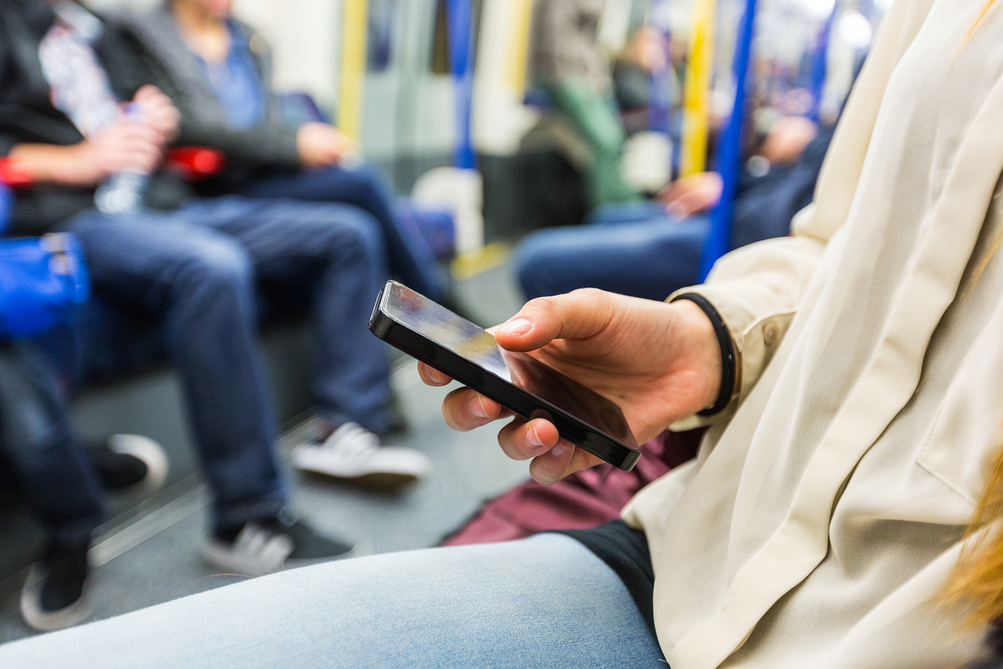 Happy,Young,Woman,Using,Mobile,Phone,In,The,Tube
